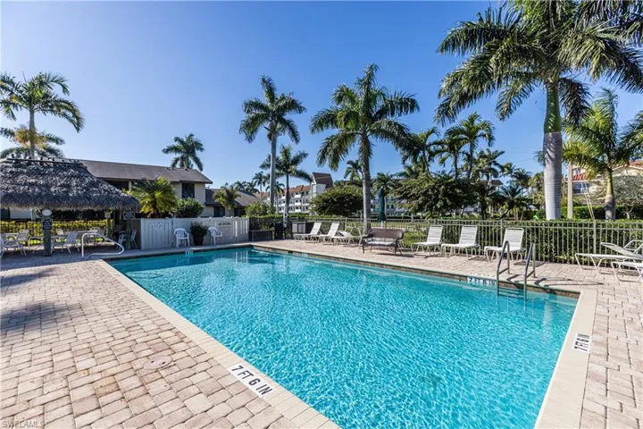 Community pool with a patio