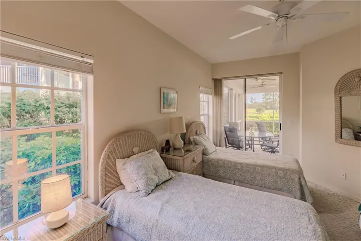 Carpeted bedroom with vaulted ceiling and ceiling fan