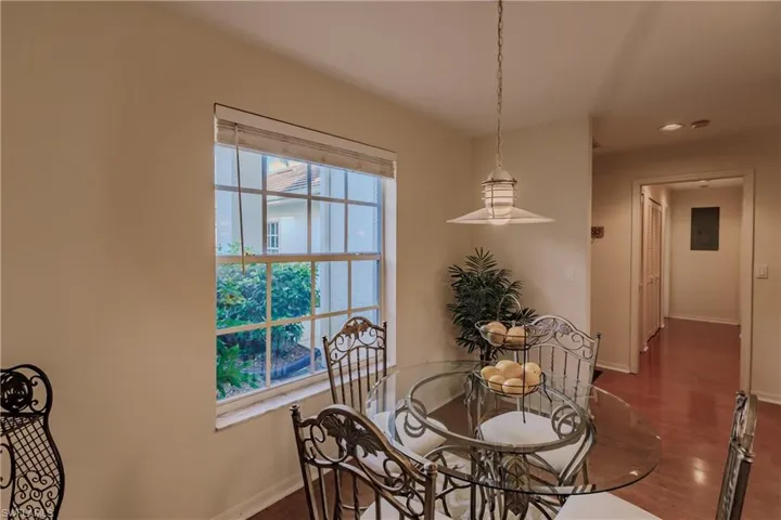 Dining room with electric panel and dark hardwood / wood-style floors