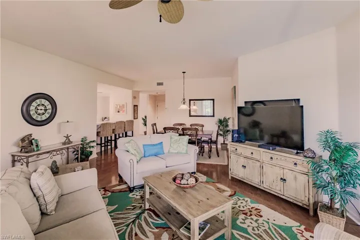 Living room featuring wood-type flooring and ceiling fan