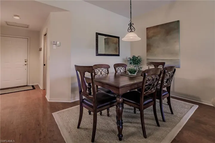 Dining room with dark hardwood / wood-style flooring