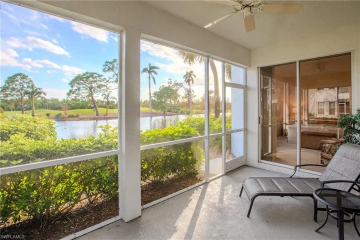 Sunroom featuring a water view and ceiling fan