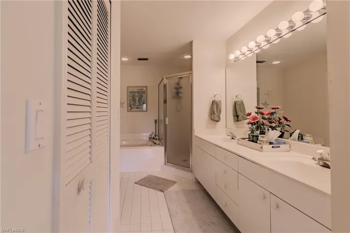 Bathroom featuring vanity, tile patterned floors, and separate shower and tub