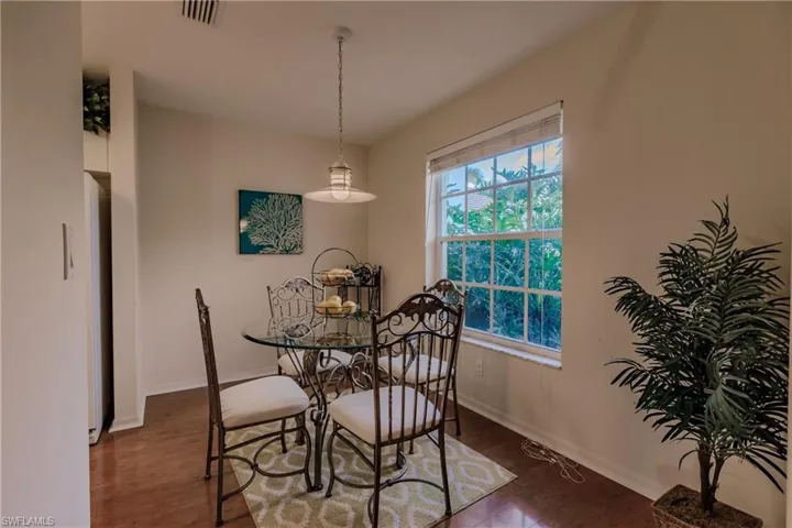 Dining room with dark hardwood / wood-style flooring