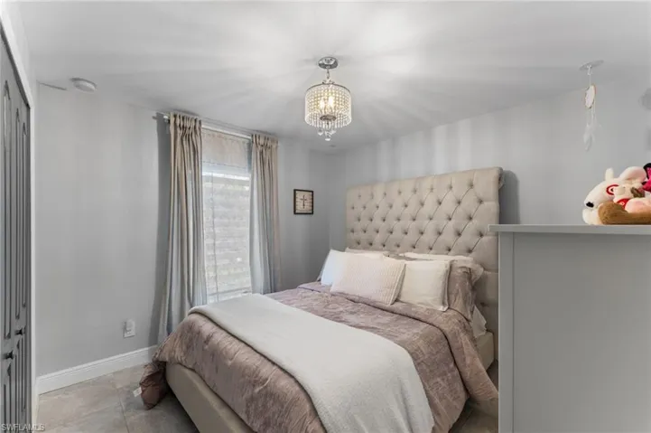Bedroom with an inviting chandelier and a closet
