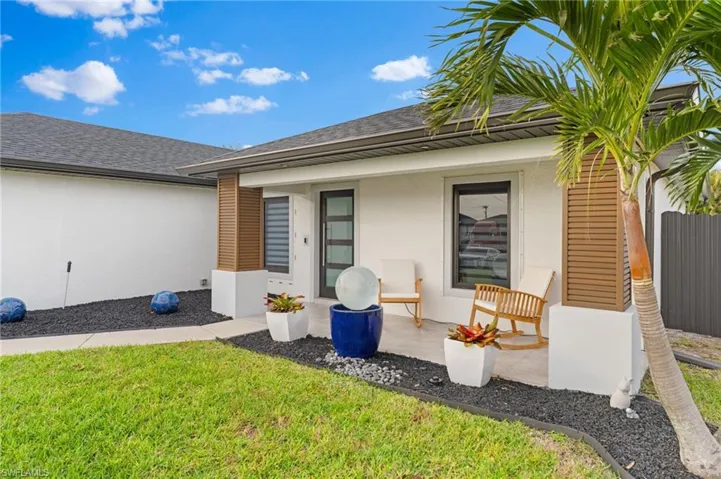 Rear view of property with a yard