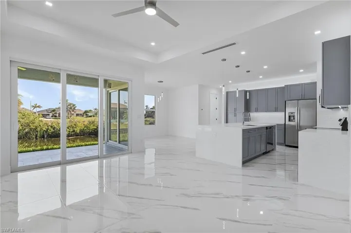 Unfurnished living room featuring light marble finish floors, recessed lighting, and ceiling fan