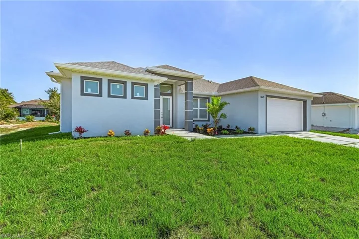 View of front of house featuring a front lawn, stucco siding, a garage, driveway, and roof with shingles