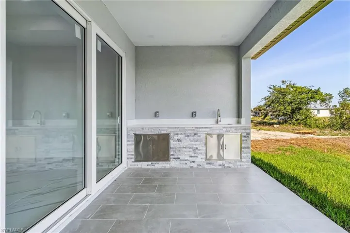 View of patio / terrace with area for grilling and a sink