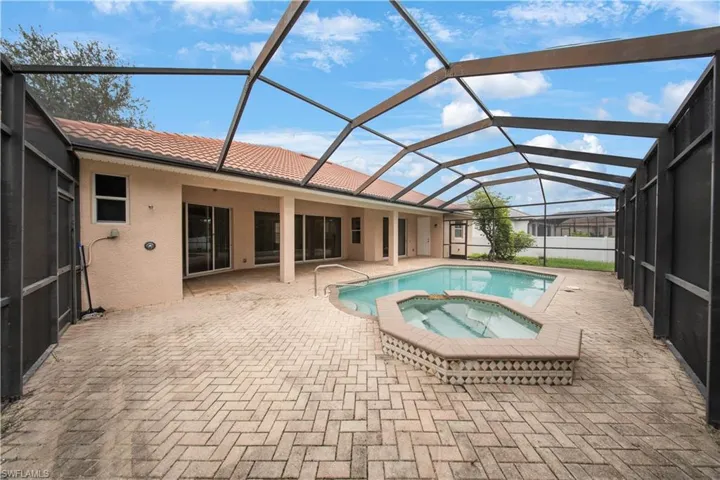 View of pool with a sunroom, a patio, a lanai, and a pool with connected hot tub