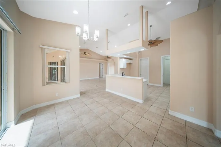 Kitchen with light tile patterned floors, a chandelier, light countertops, a ceiling fan, and recessed lighting