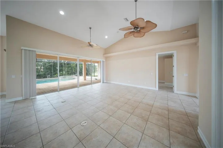 Spare room with high vaulted ceiling, recessed lighting, light tile patterned flooring, and ceiling fan