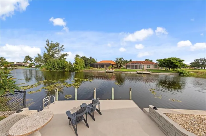 Dock with a water view and a patio area
