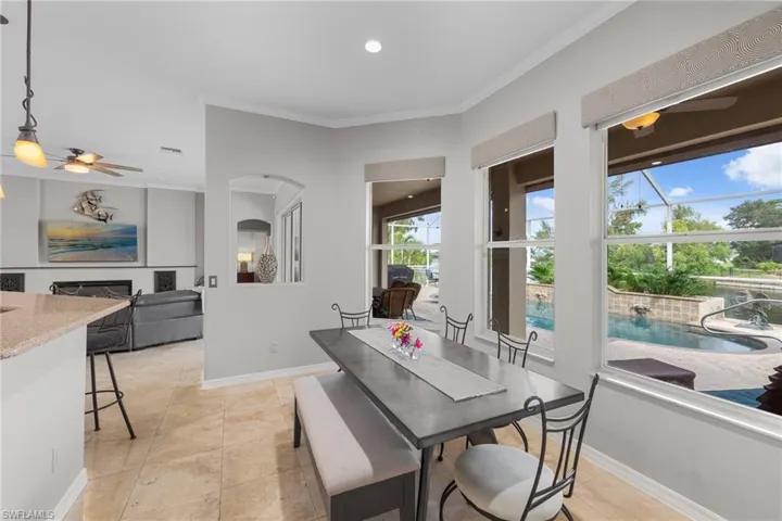 Dining area with ornamental molding, ceiling fan, light tile patterned floors, and recessed lighting