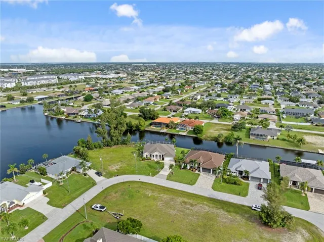 Aerial overview of property's location featuring nearby suburban area and a nearby body of water