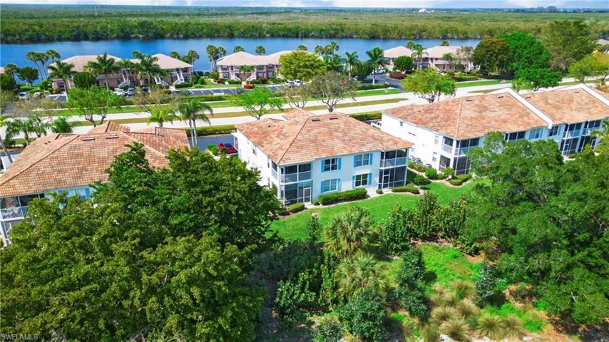 Aerial view of residential area featuring a nearby body of water