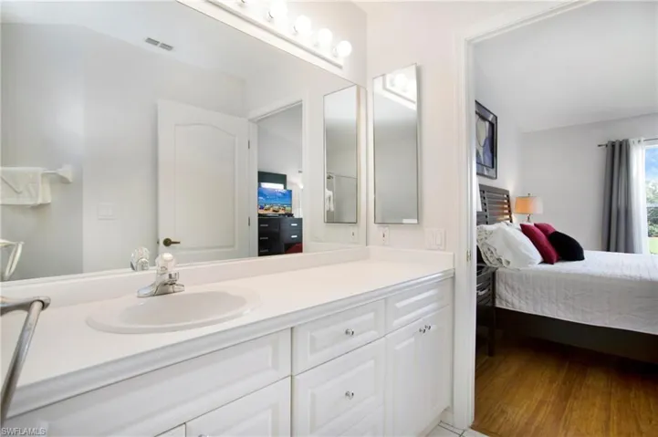 Ensuite bathroom featuring vanity and light wood finished floors