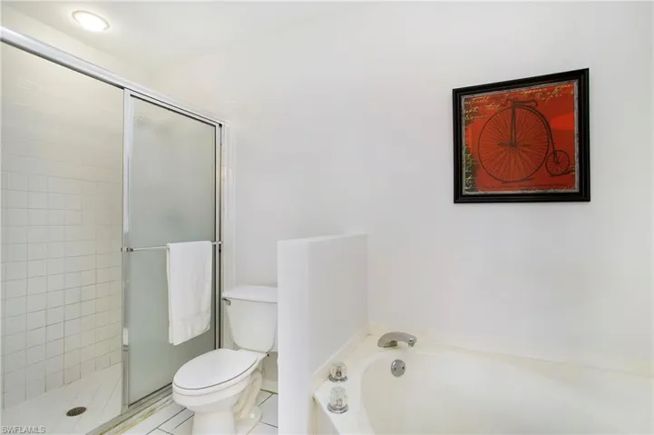 Bathroom featuring a stall shower, a bath, and tile patterned floors