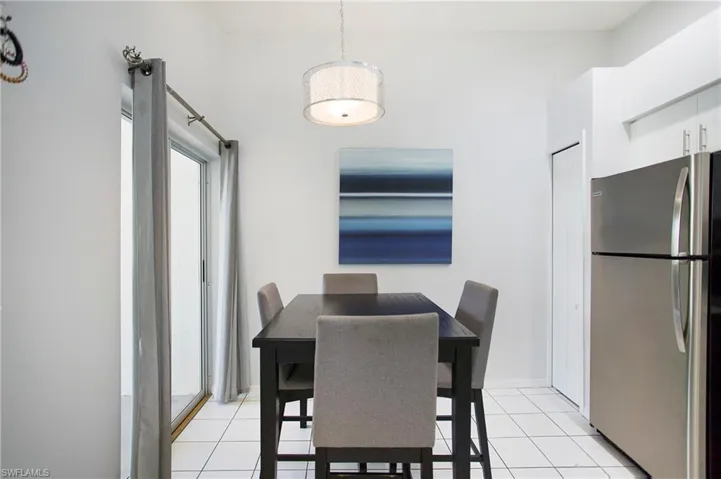 Dining area with light tile patterned flooring