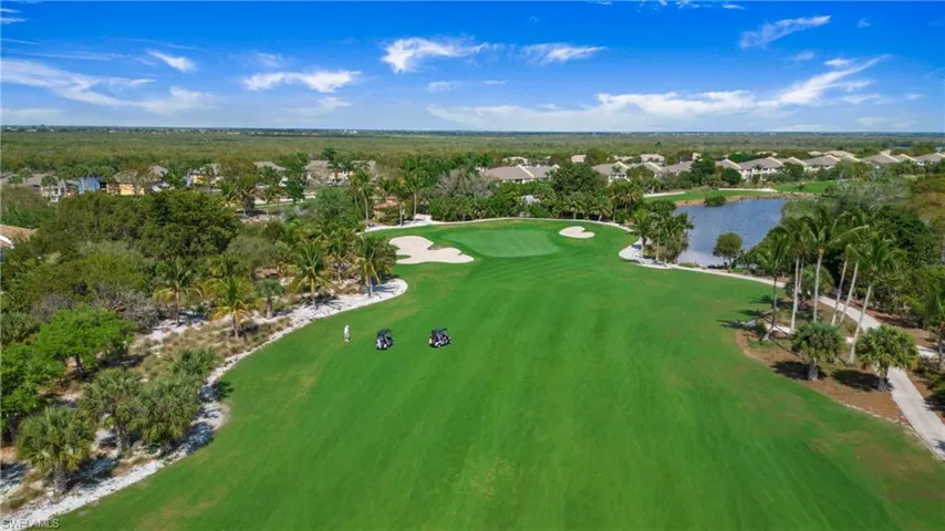 Aerial overview of property's location featuring a golf club, a nearby body of water, and nearby suburban area