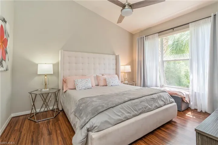 Bedroom featuring ceiling fan, vaulted ceiling, and dark hardwood / wood-style flooring