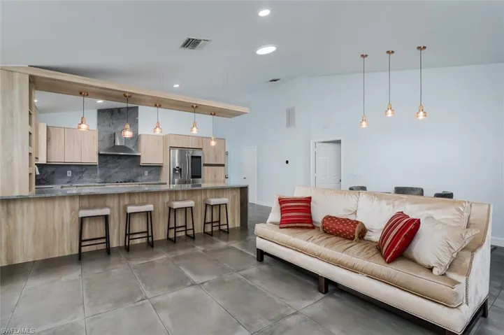Living room with recessed lighting and vaulted ceiling