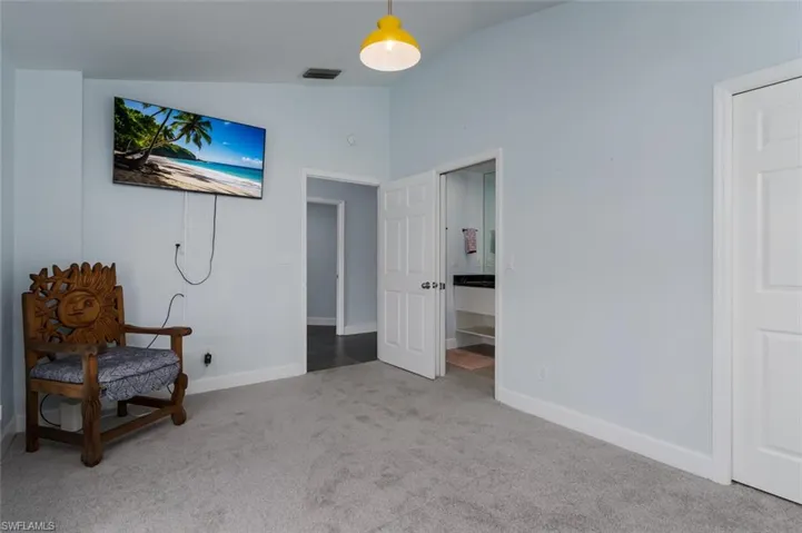 Living area featuring light colored carpet and lofted ceiling