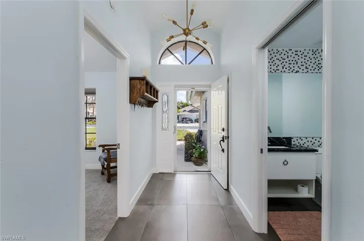Foyer entrance featuring healthy amount of natural light and a high ceiling