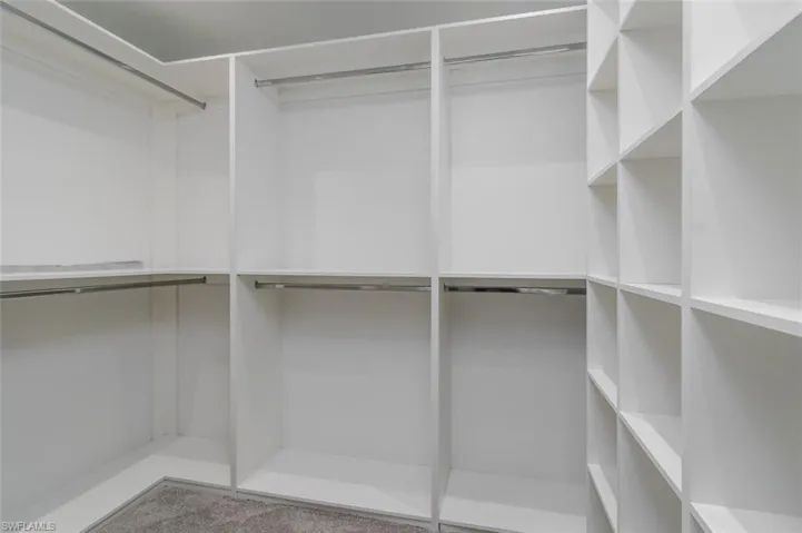 Walk in closet featuring carpet flooring