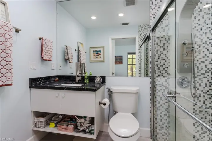 Full bathroom featuring vanity, a shower stall, and recessed lighting