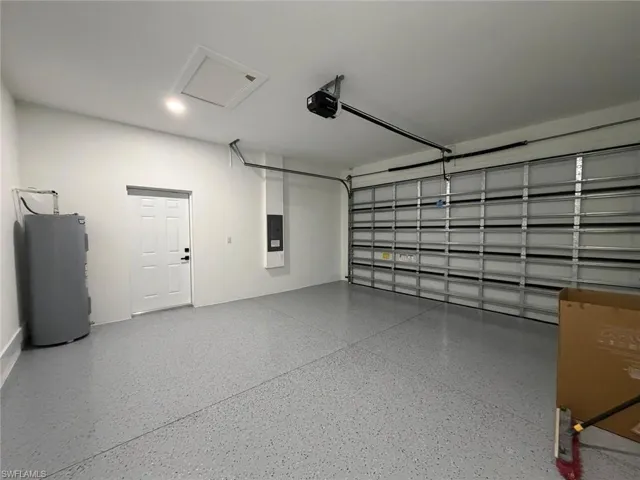 Spacious two-car garage featuring a gray speckled epoxy floor finish