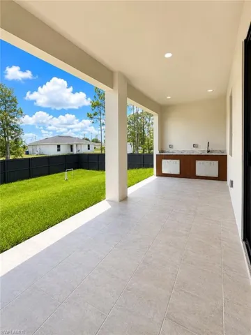 Covered patio featuring rectangular tile flooring and recessed lighting