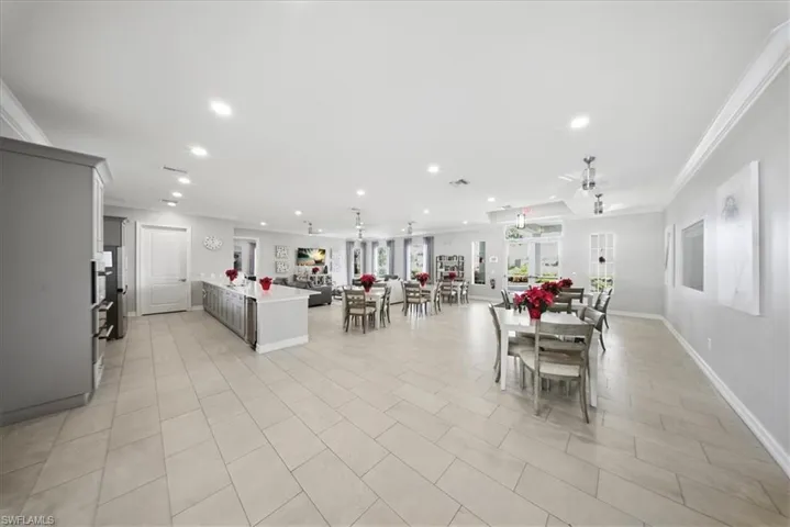 Dining area with crown molding, recessed lighting, and light tile patterned flooring