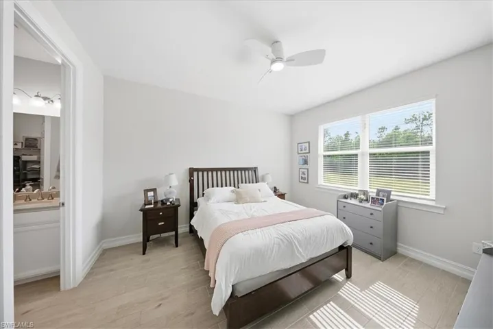Bedroom with light wood-style floors and ceiling fan