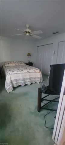 Bedroom featuring a closet and a ceiling fan