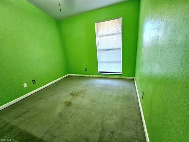 Empty room featuring baseboards