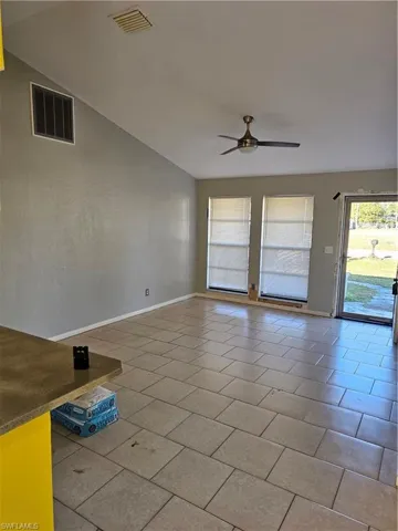 Empty room with visible vents, a ceiling fan, and tile patterned flooring