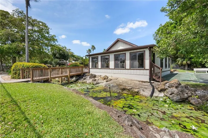 Tropical Pool has waterfall and pond with Outdoor kitchen and rec room