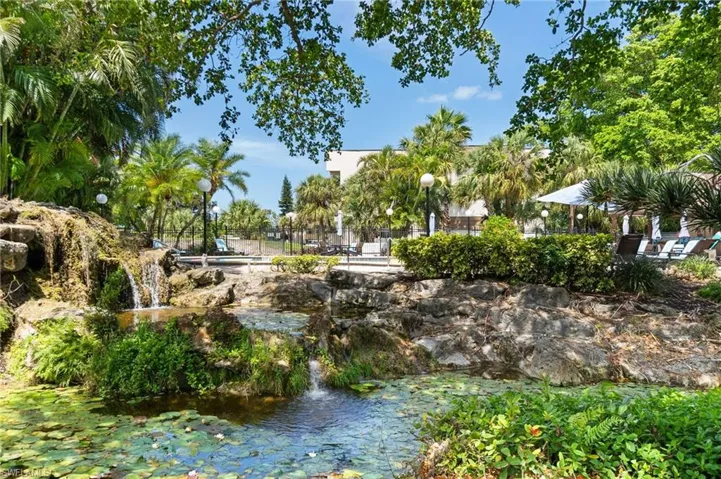 Tropical Pool has waterfall and pond with Outdoor kitchen and rec room