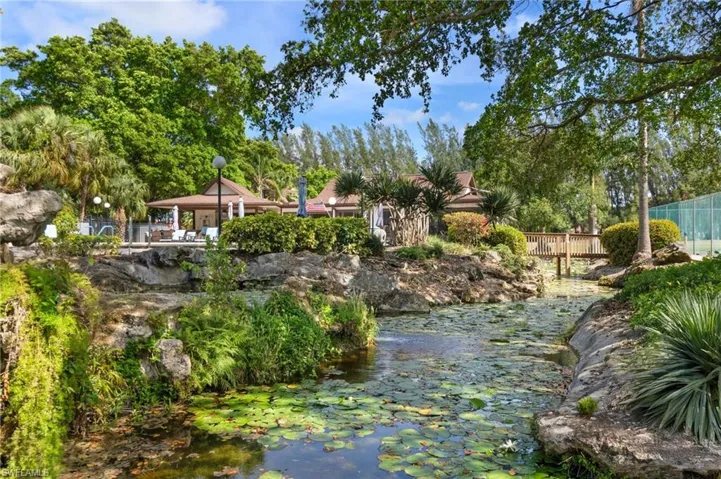 Tropical Pool has waterfall and pond with Outdoor kitchen and rec room