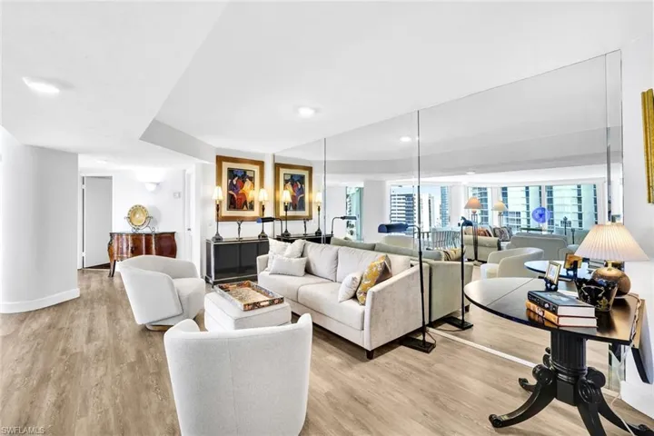 Living room with recessed lighting, light wood finished floors, and baseboards