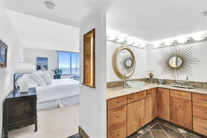 Bathroom featuring ensuite bathroom, a sink, marble finish floor, double vanity, and visible vents