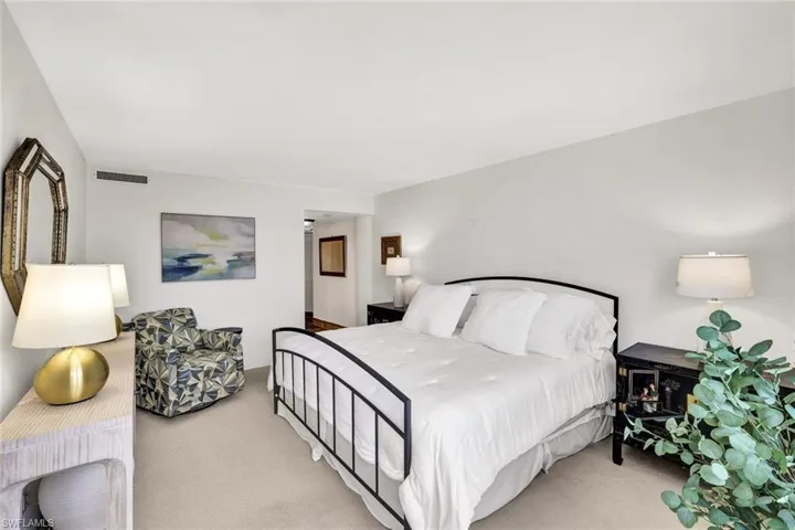 Bedroom with visible vents and carpet floors