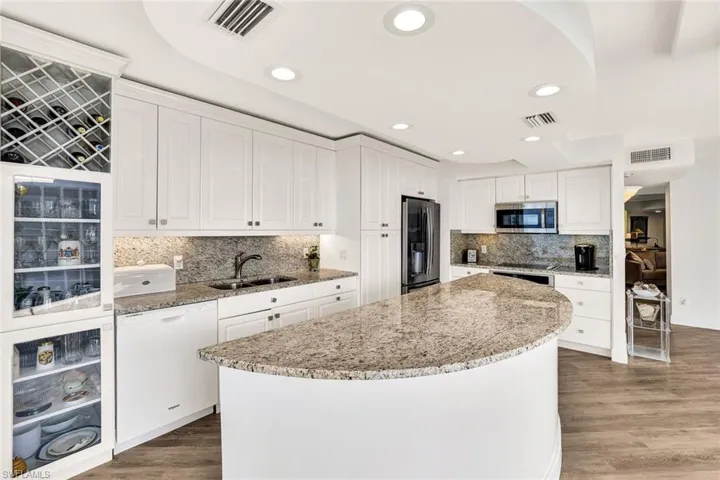 Kitchen featuring appliances with stainless steel finishes, a sink, visible vents, and a kitchen island