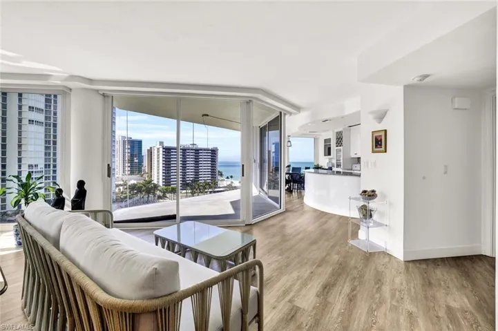 Living room featuring light wood-style flooring, baseboards, and floor to ceiling windows
