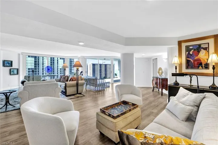 Living area featuring baseboards, a healthy amount of sunlight, and wood finished floors