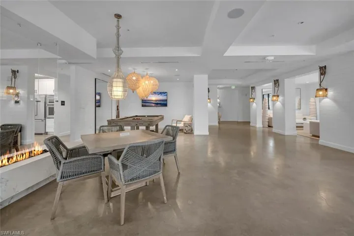 Dining space featuring concrete floors and a raised ceiling
