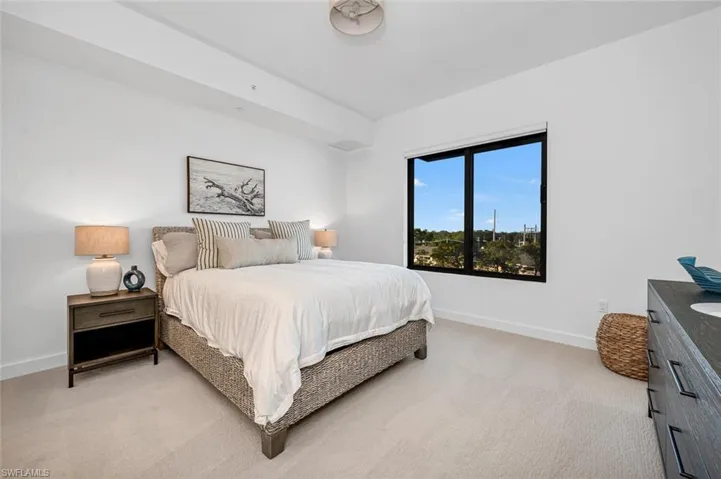 Bedroom with light colored carpet