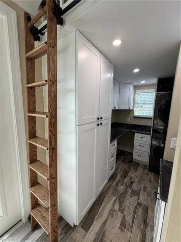 Pantry featuring stacked washer / dryer