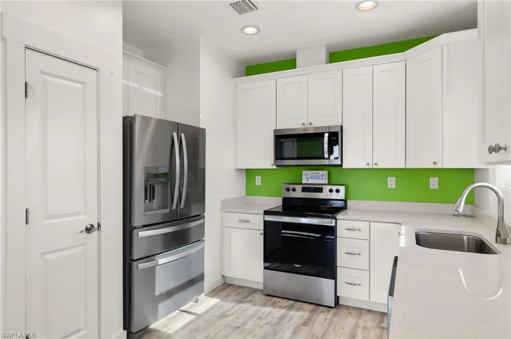 Kitchen with pantry and stainless steel appliances